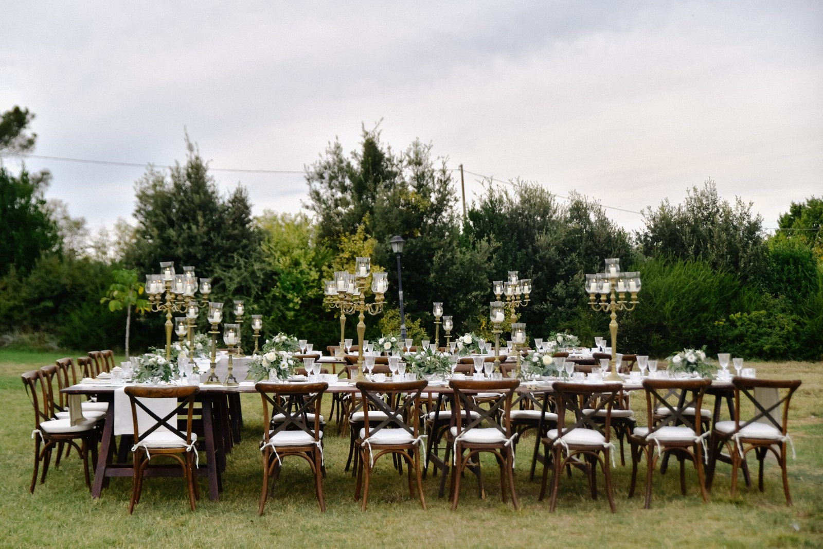 Decorated wedding celebration table with guests seats outdoors in the gardens